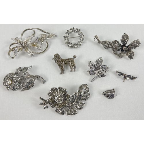 1088 - A collection of 8 vintage marcasite set brooches. To include Orchid flowers, Poodle and maple leaf d... 