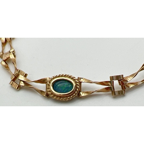 1036 - A 9ct gold decorative link bracelet with set 3 oval cut opal stones in bezel set mounts. With rope b... 