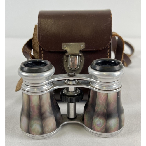 1284 - A pair of mother of pearl set opera glasses with a leather carry case.