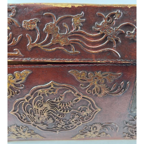 1288 - A vintage red leather trunk with Oriental floral & character relief design to front & sides. Drop me... 