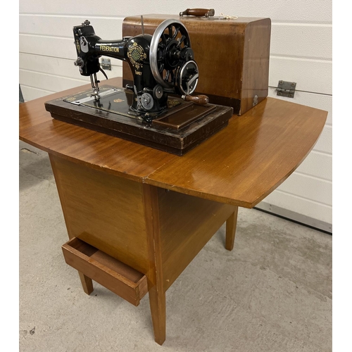 1350 - An early 20th century Jones CWS Federation Family hand sewing machine in a vintage sewing machine ta... 