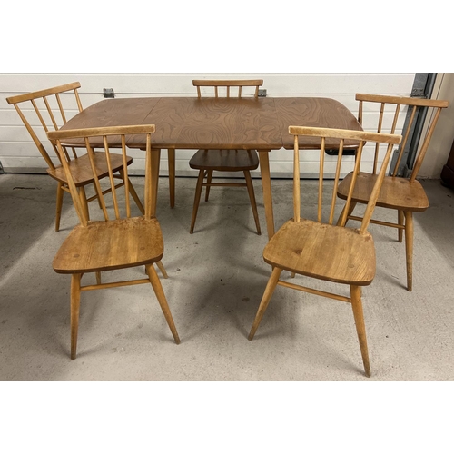 1351 - A mid century blond Ercol drop leaf dining table with 5 Ercol chairs. Rectangular shaped extending t...