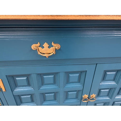 1356 - A modern solid wood sideboard with natural wood top and teal painted base. 4 cupboards to base with ... 