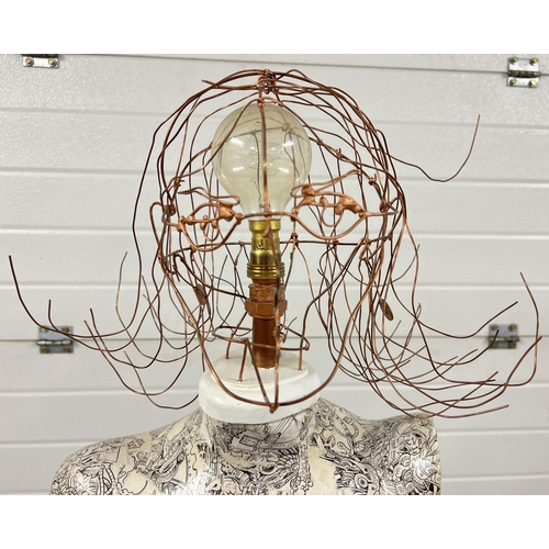 1361 - A modern design standard lamp made from a female mannequin and wire head design lampshade. With blac... 