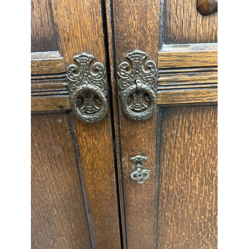 1363 - A vintage Old Charm dark oak double wardrobe with linenfold design to doors. Of Gothic design with d... 