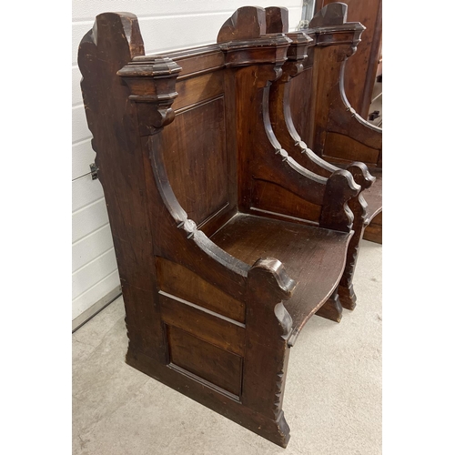 1365 - A pair of antique dark oak church sideman's pew chairs. With panelled backs and shaped arms. Each ap... 