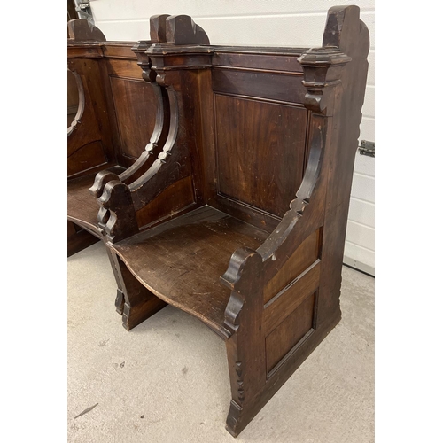 1365 - A pair of antique dark oak church sideman's pew chairs. With panelled backs and shaped arms. Each ap... 