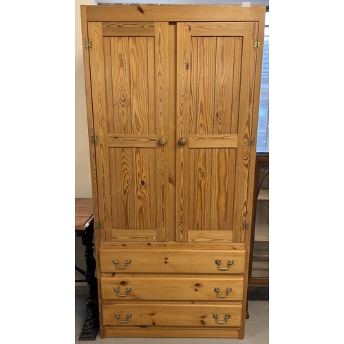 1369 - A vintage pine double door wardrobe with 3 lower drawers. Interior hanging rail and hooks. Approx. 1... 