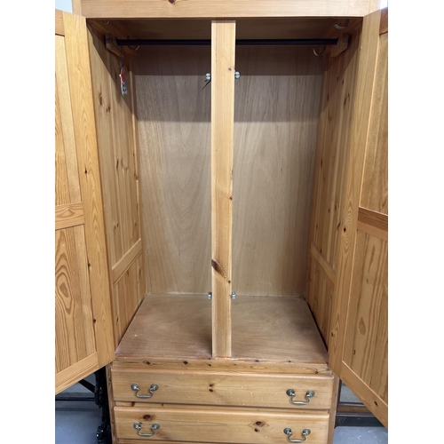 1369 - A vintage pine double door wardrobe with 3 lower drawers. Interior hanging rail and hooks. Approx. 1... 