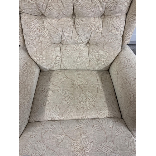 1375 - A modern T Motion electric recliner armchair with cream coloured floral upholstery. Complete with po... 