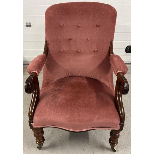 1379 - A Victorian mahogany low nursing chair with carved front legs and scroll design arms. With dark pink... 