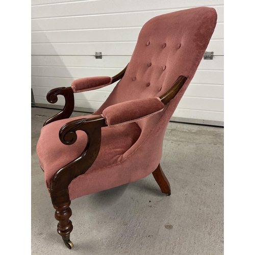 1379 - A Victorian mahogany low nursing chair with carved front legs and scroll design arms. With dark pink... 