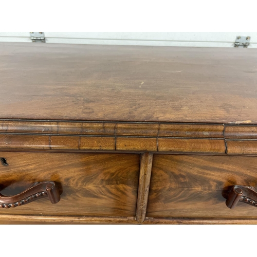 1387 - An antique wood 2 over 3 chest of drawers with decorative wooden looped handles. Raised on bun feet,... 