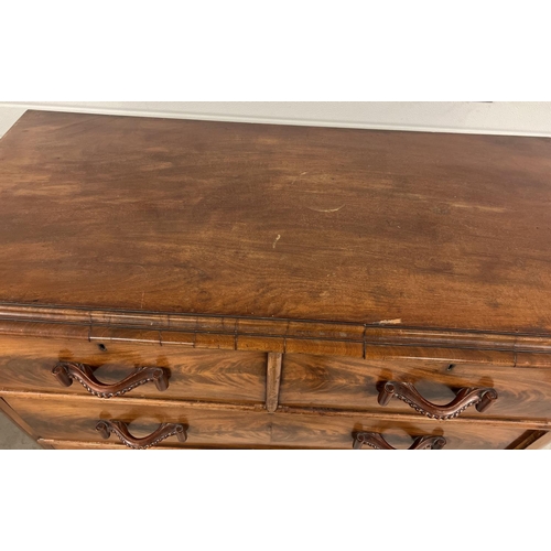 1387 - An antique wood 2 over 3 chest of drawers with decorative wooden looped handles. Raised on bun feet,... 