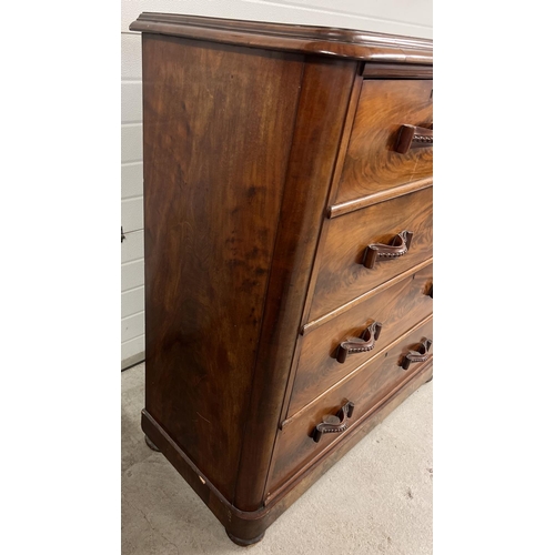 1387 - An antique wood 2 over 3 chest of drawers with decorative wooden looped handles. Raised on bun feet,... 