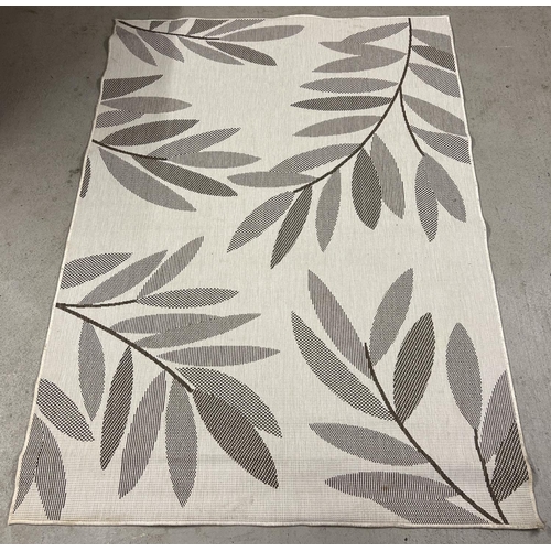 1388 - A modern reversible rug with foliate design in neutral tones. Approx. 222cm x 160cm.