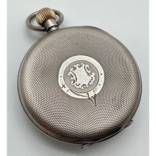 1168 - A vintage silver pocket watch with secondary dial. White enamel face with black steel hands Back nee... 