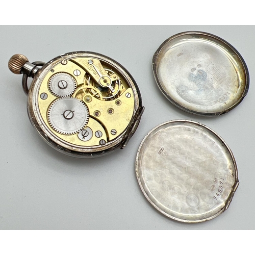 1168 - A vintage silver pocket watch with secondary dial. White enamel face with black steel hands Back nee... 