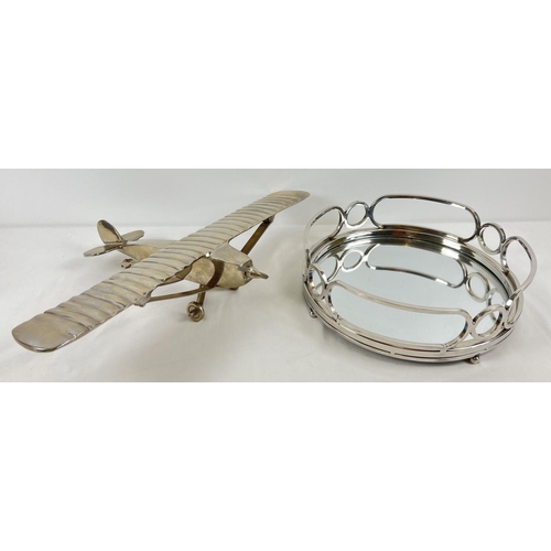 1200 - 2 modern metal items. A large aluminium aeroplane ornament with moving wheels and propeller. Togethe... 