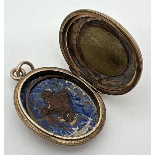 1002 - An antique 9ct gold front and back locket with blue enamel and cross design, set with seed pearls to... 