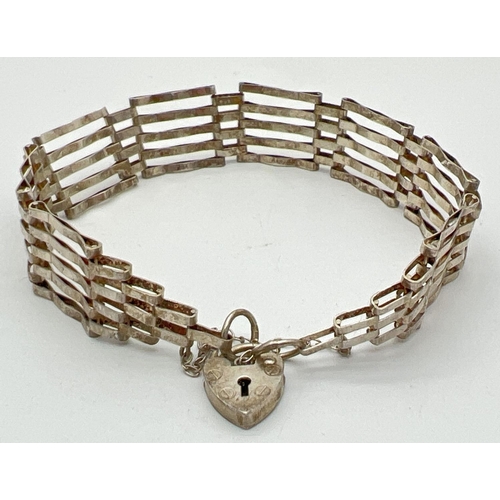 1079 - A vintage silver 5 bar gate bracelet with padlock and safety chain. Silver marks to back of padlock.... 