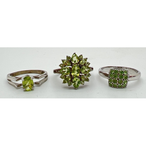 1086 - 3 peridot set silver dress rings. A floral design cluster style ring set with 17 varying cut peridot... 