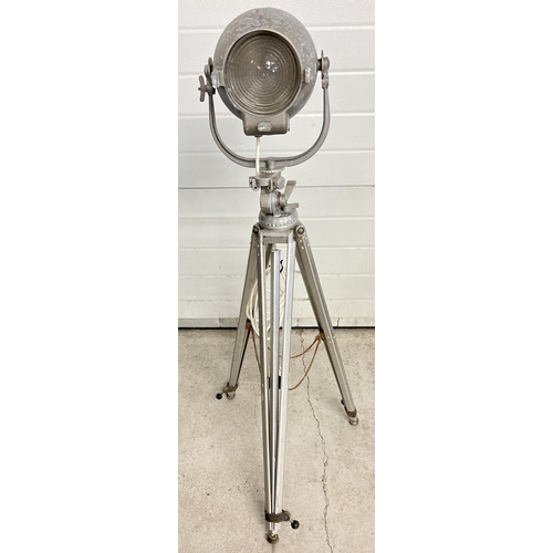 1347 - A vintage 1940's Strand Electric theatre spotlight on a vintage Bolex Paillard cinecamera tripod bas... 