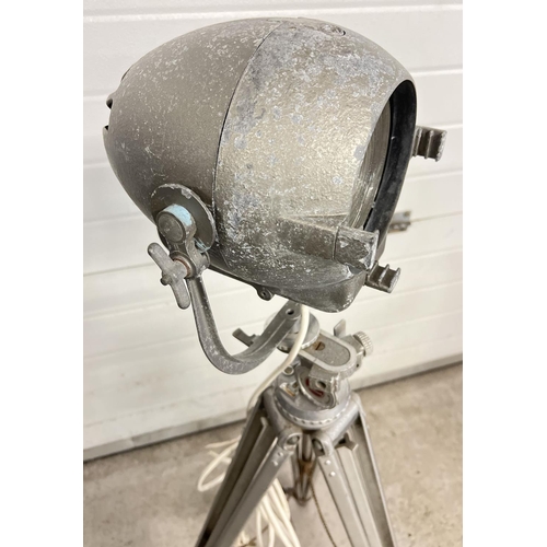 1347 - A vintage 1940's Strand Electric theatre spotlight on a vintage Bolex Paillard cinecamera tripod bas... 