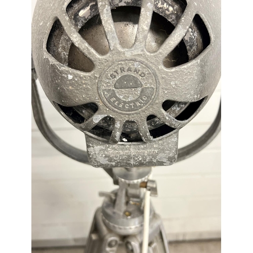 1347 - A vintage 1940's Strand Electric theatre spotlight on a vintage Bolex Paillard cinecamera tripod bas... 