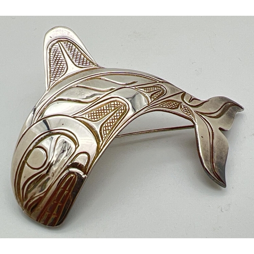 1087 - A Northwest Coast design silver Orca whale pendant/brooch. Signed PS to back and indistinct silver m... 