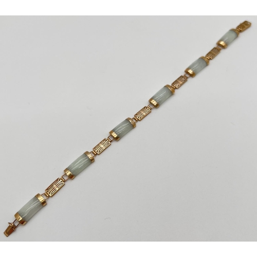 1089 - A 9ct gold and green jade panel bracelet with push clasp. Alternating rectangular pierced work chine... 