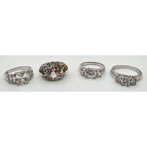 1092 - 4 silver and white metal clear stone set cocktail rings. To include 2 x past, present and future sty... 