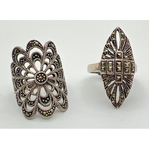 1098 - 2 large silver marcasite set dress rings. An Art Deco style marquise shaped ring (size R) together w... 