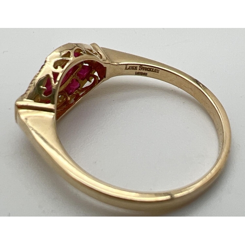 1099 - An Art Deco style ruby and diamond set dress ring by Luke Stockley, London. A marquise cut central r... 