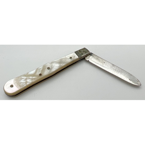 1192 - A small antique pearl handled silver fruit knife with empty cartouche. Hallmarked for Sheffield 1902... 