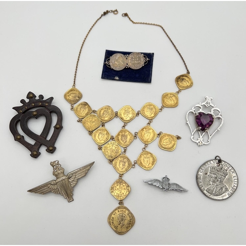 1106 - A small collection of jewellery and badges. To include a small brooch made of 2 Victorian sixpences,... 