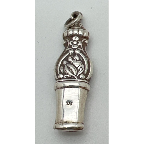 1182 - A 925 silver whistle with floral decoration and hanging bale. Approx. 6cm long.