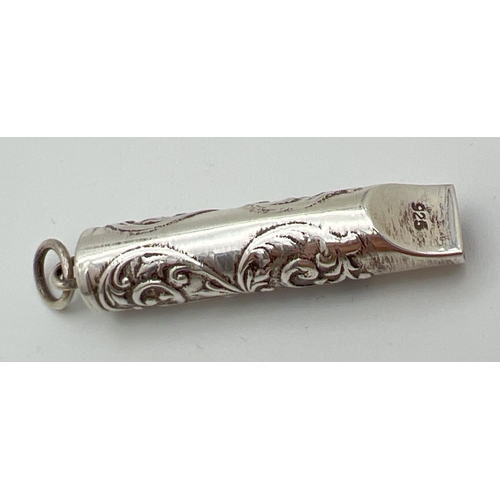 1183 - A small silver whistle with scroll and floral decoration and empty cartouche. Silver mark to undersi... 