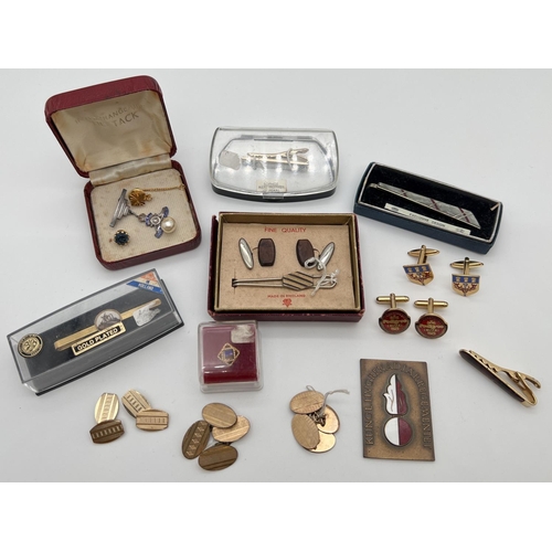 1109 - A collection of vintage tin pins, cufflinks and tie slides together with a silver military pin badge... 