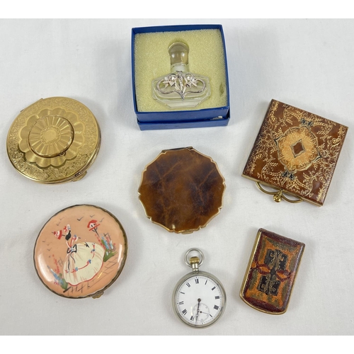 1317 - A tin containing 5 assorted vintage compacts, a boxed scent bottle & a white metal cased pocket watc... 