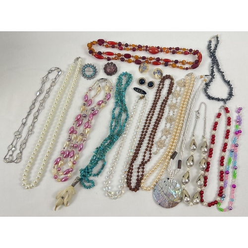 1118 - A collection of costume jewellery to include glass bead and natural stone necklaces, brooches and cl... 