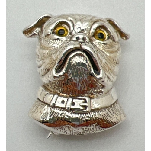 1120 - A sterling silver brooch/pendant in the shape of a dogs head with yellow glass eyes. Reverse with pi... 