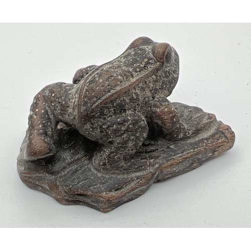 1246 - A small carved dark wood figure of a frog. Approx. 2.5cm tall x 4.75cm long.