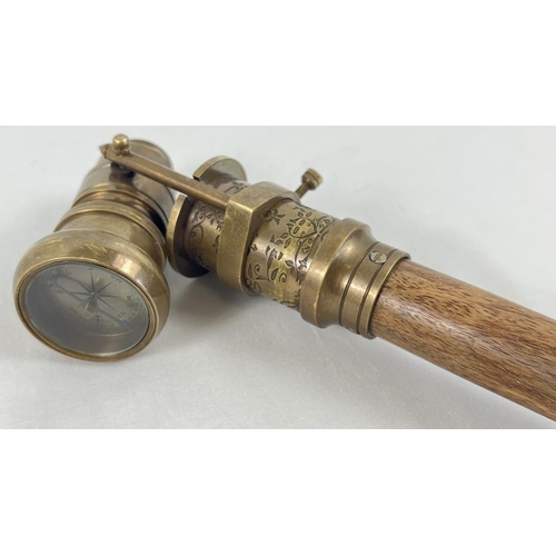 1296 - A reproduction wood and brass walking stick with swivel top telescope/compass handle. Approx. 95.5cm... 