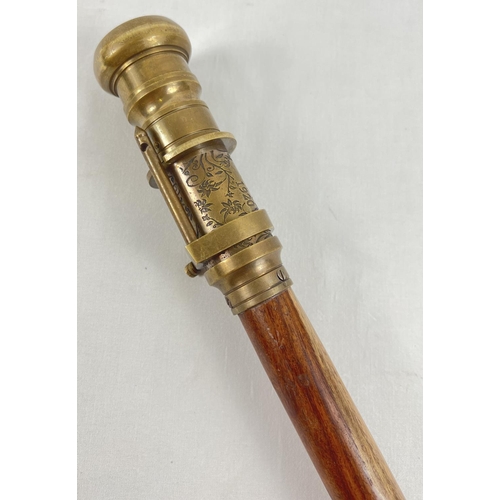 1296 - A reproduction wood and brass walking stick with swivel top telescope/compass handle. Approx. 95.5cm... 