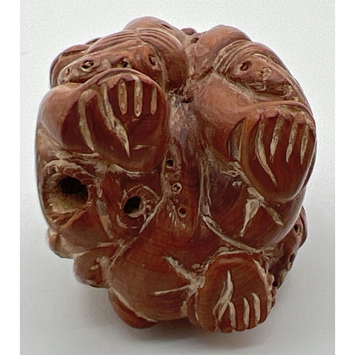 1248 - A carved wooden netsuke of monkeys and an octopus. Toggle holes to underside. Approx. 4.5cm tall.