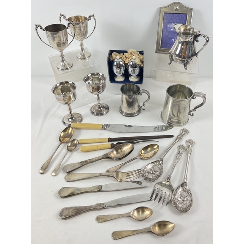 1198 - A collection of vintage silver plated items. To include Viners milk jug, golfing trophy cups, glass ... 