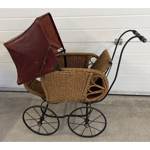 1316 - A large reproduction basket weave and leather dolls pushchair with black metal frame & wooden handle... 