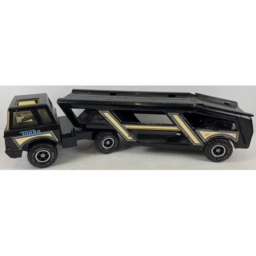 1317 - A vintage Tonka MR970 black pressed steel car transporter, with decals.