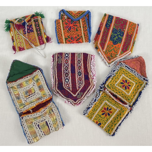 1375 - 6 Central Asian heavily embroidered wrap pouches, in varying colours, sizes and designs. Some with b... 